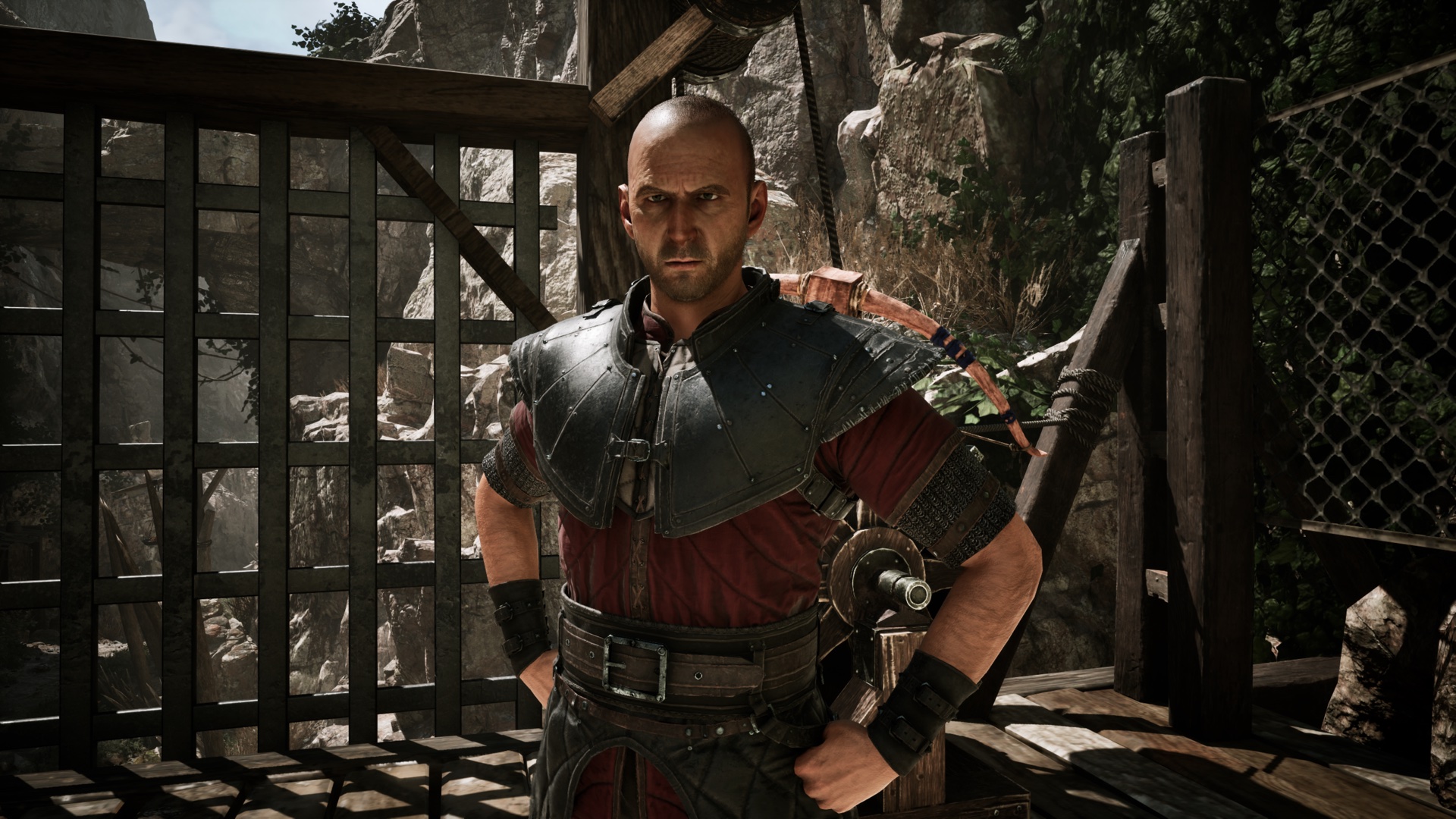 Gothic 1 Remake Fisk guide — a fighter in the Old Camp's dark-and-red leathers with a sword at his hip, before a latticed timber gate