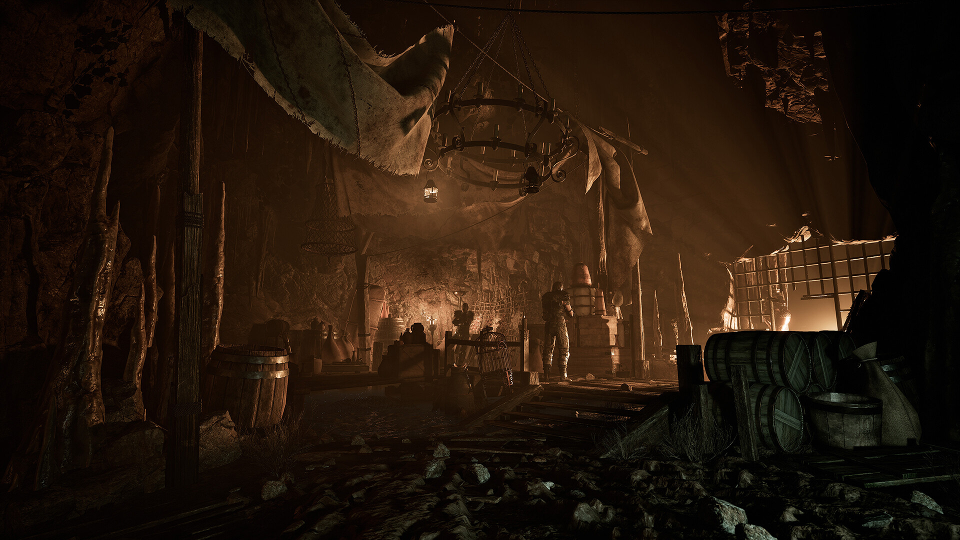 Gothic 1 Remake Old Camp — a firelit hall hung with banners and stacked barrels, comfort bought with ore