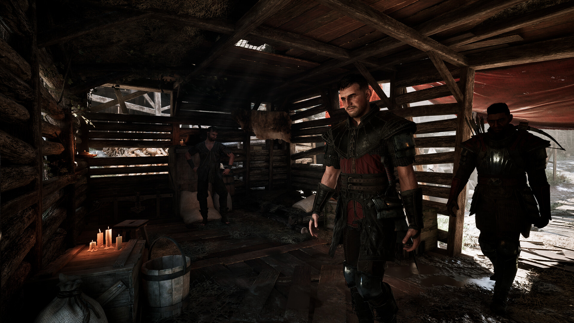 Gothic 1 Remake Old Camp — armoured fighters in a timber hall lit by candlelight, the ranks a new Shadow joins